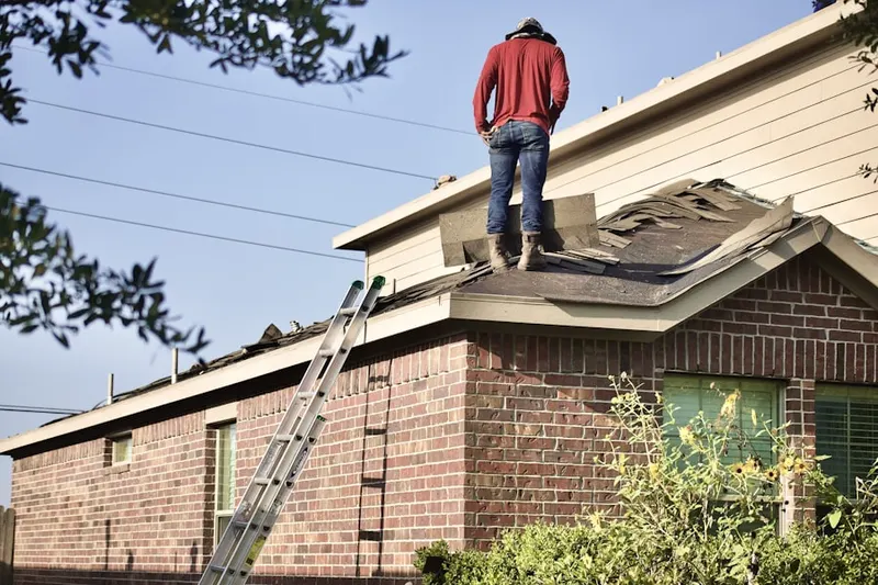 Professional roofer working on a residential roof in Anselma